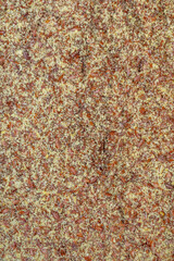 Crushed linseed seed background, top view. Dry and crushed linseed seeds, background, texture, top view. Pile of crushed linseed seeds. Background from crushed linseed seeds, texture.