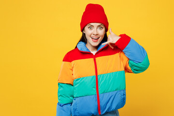 Young surprised happy woman she wear padded windbreaker jacket red hat casual clothes doing phone...
