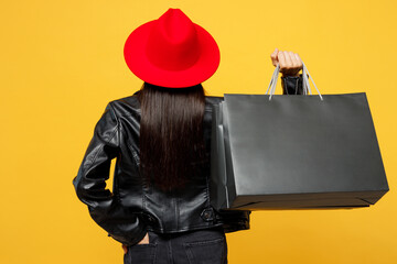 Back rear view young woman wear casual clothes red hat hold showing raise up hands with blank...