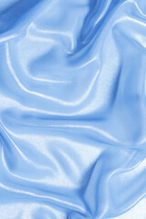 Blue shiny pearl fabric as a background.