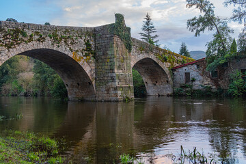 Fototapeta premium Medieval stone bridge over the Arnoia river in the town of Allariz. Province of Ourense. Galicia, Spain