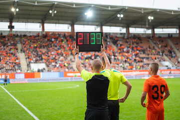 Team manager man shows players substitution during football match. - obrazy, fototapety, plakaty