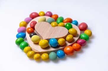 A Colorful Heart Shaped Wooden Toy Surrounded by Vibrant, Playful, and Cheerful Beads