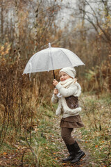 Portrait of a girl playing with an umbrella - she raised it up.