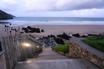 Steps leading to surfer's beach at dawn