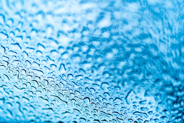 Obraz premium Close Up of Rainy Window with Water Droplets. A close up of a window with drops of water on it