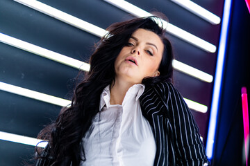 A Stylish Businesswoman with Sleek, Dark Locks Rocking a Professional Attire. A woman with long...