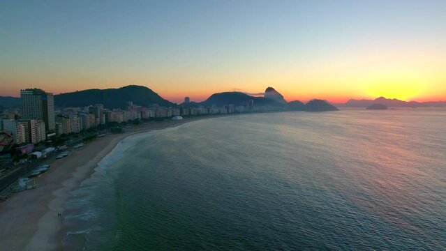 Aerial Panning Shot Of Waves On Sea At Copacabana Beach In City Against Sky During Sunrise - Rio de Janeiro, Brazil