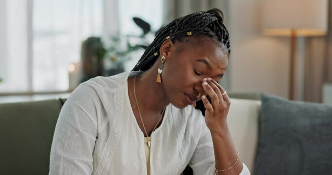Headache, burnout and young black woman in the living room of her modern apartment on weekend. Stress, mental health and sick African female person with migraine for illness in lounge at home.