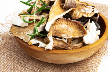 Dry slices of different mushrooms in a wooden bowl as gourmet food ingredient, Vegetable organic...