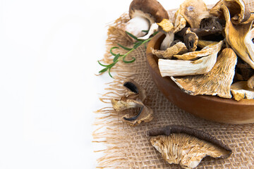 Dry slices of different mushrooms in a wooden bowl as gourmet food ingredient, Vegetable organic protein trend food.