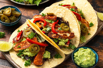 Fried halloumi fajitas with pan roasted onions and bell peppers, avocado guacamole and pickled jalapeno peppers