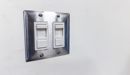 light switch in a dimly lit room, symbolizing the concept of electricity conservation and energy-saving practices in everyday life