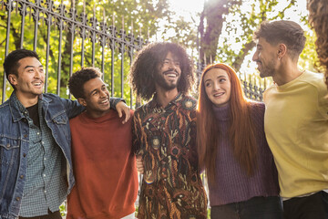 Multiethnic boys and girls taking selfies outdoors with backlight - Happy lifestyle friendship concept for young multicultural people having fun together madrid - obrazy, fototapety, plakaty