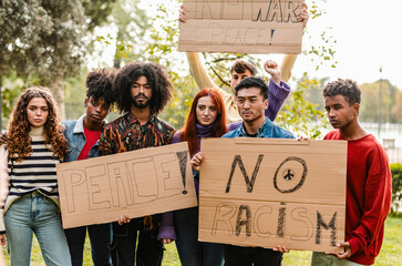 Group of multicultural teenage activists protesting against war and violence in the streets, and racism, in the city. Generation Z protesters - obrazy, fototapety, plakaty