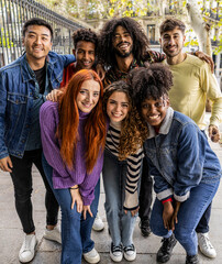 Fototapeta premium Multiracial young group of happy people taking selfie portraits - Diverse millennial friends laughing and having fun together, city travelers, students.