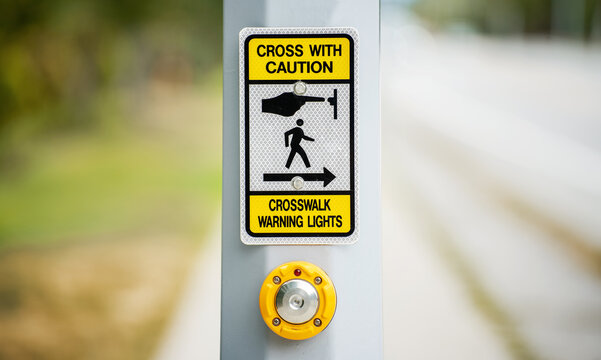 Traffic sign. Push button to turn on crosswalk warning light