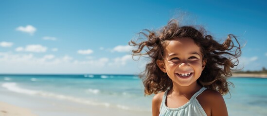 Joyful young girl on holiday at the beach looking cute