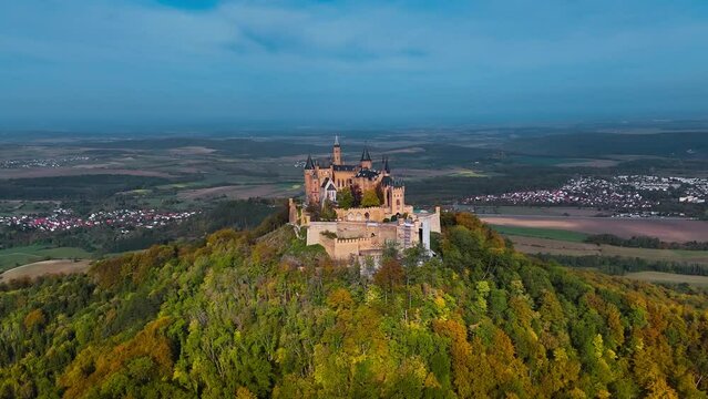 Aerial drone view of medieval Hohenzollern castle on top of hill in autumn, Baden-Wurttemberg, Germany. High quality 4k footage