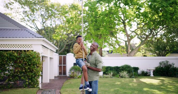 Father, black child and swing at backyard, happy at home and bonding together. Dad push kid on rope, play outdoor at garden and smile of African family having fun, care and love in summer at house