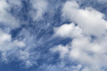 White clouds against a blue sky background
