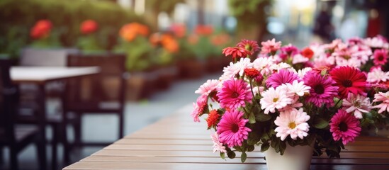Naklejka premium Patio cafe with blurred flowers in foreground and one central pink flower