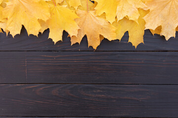 Autumn leaves frame on one up side wooden background top view Fall Border yellow and Orange Leaves vintage wood table Copy space. Mock up for your design. Display for product or text