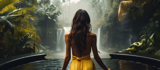 Bali series photo of woman in yellow dress posing by pool with jungle view