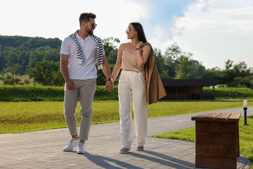 Romantic date. Beautiful couple walking in park on sunny day