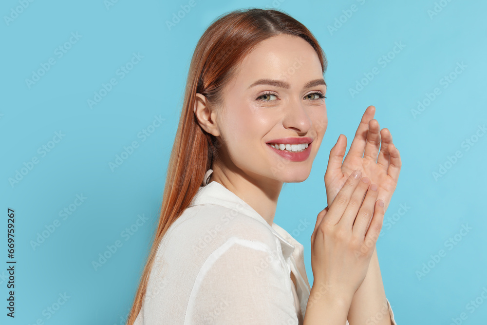 Poster Beautiful young woman on light blue background