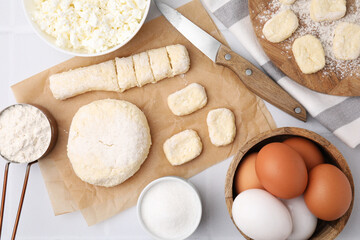 Making lazy dumplings. Raw dough, ingredients and knife on white tiled table, flat lay