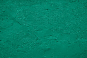 Wall background. Rough grain uneven grungy plaster texture surface. Blue mint teal jade emirald green color. Oil paint. Urban vintage exterior. Close-up. For design. Template.
