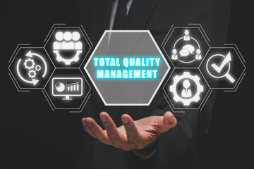Total quality management concept, Businessman hand holding total quality management icon on virtual screen. - obrazy, fototapety, plakaty