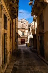 The narrow streets of the baroque style city of Modica, Sicily, Italy - 669770094