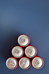 close up group of aluminium red cans soft drink put on blue texture background