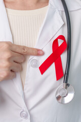 Doctor with Red Ribbon for December World Aids Day, acquired immune deficiency syndrome, multiple...