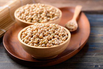Soybean seed in bowl on wooden background, Healthy ingredients in vegan food