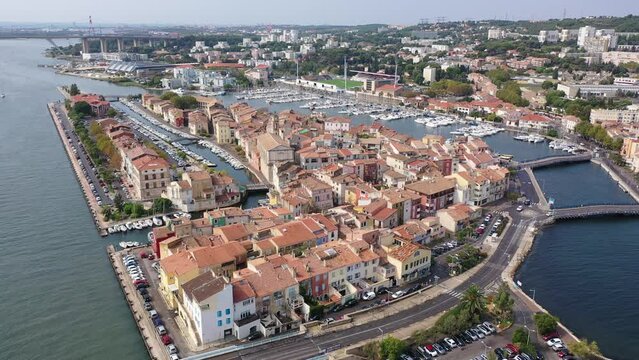 Aerial panoramic view of landscape of old town of Martigues on Mediterranean coast with scenic canals and marina on summer day, Bouches-du-Rhone department, France