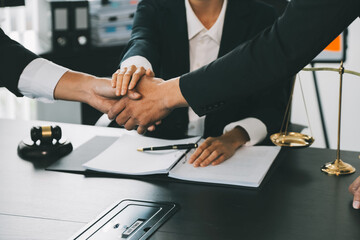 Businessman shaking hands to seal a deal with his partner lawyers or attorneys discussing a contract agreement