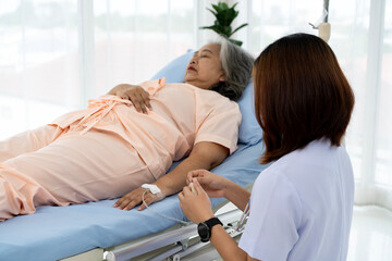 Obraz premium Nurse are verifying the accuracy of giving Saline to patients. Caregiver or nurse and senior concept.