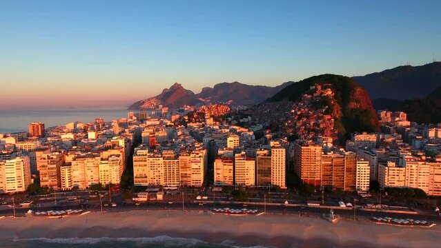 Aerial Forward Shot Of Buildings In City Near Mountains And Sea Against Sky At Sunrise - Rio de Janeiro, Brazil