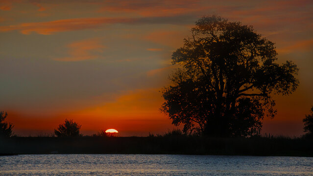 Sun peeking over the horizon early morning sunrise on the delta