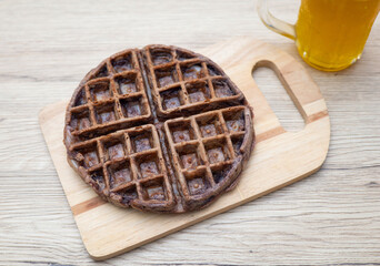 Dessert waffles placed on a wooden table surface