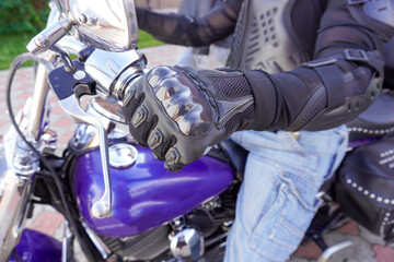 Fototapeta na wymiar Motorcyclist in protection on a motorcycle close-up