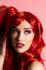 Beautiful Young Women with Scarlet Red Hair Posing with Valentine's Decor in a Hot Red Jumper