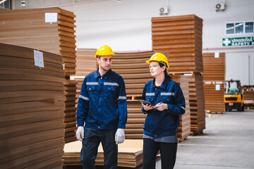 Factory manager, foreman worker checking stock inventory on good shelf in delivery storehouse of...