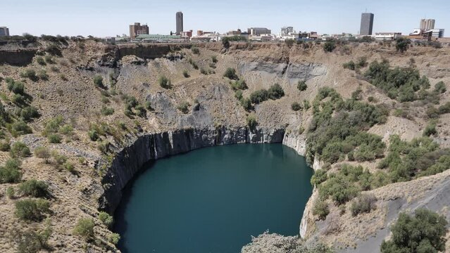Tilt up from flooded Big Hole diamond mine to city of Kimberley, RSA