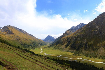 Ak-Suu valley with a glacier river on Fifth stage of Ak-Suu Traverse trek in Tian Shan mountains,...