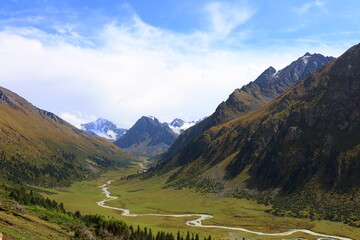 Ak-Suu valley with a glacier river on Fifth stage of Ak-Suu Traverse trek in Tian Shan mountains,...