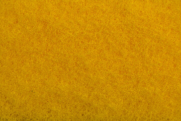 Fototapeta premium Sponge texture background. Close-up of yellow bath sponge with porous structure for background. Macro photo.